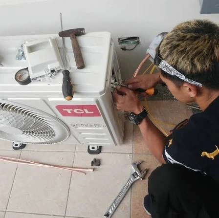 Technician troubleshooting an outdoor air conditioning unit